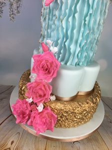 gold blue and pink wedding cake
